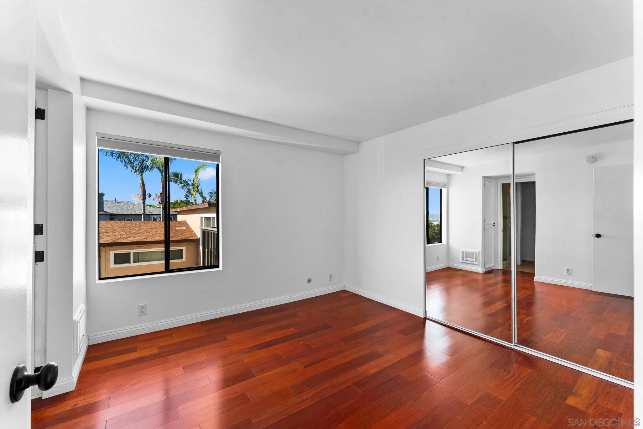 1670 Guy Street, Unit B San Diego, CA 92103 - Photo 20 of 44 a view of an empty room with wooden floor and a window