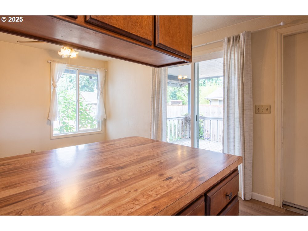 4631 Daisy Street Springfield, OR 97478 - Photo 14 of 46 a view of an empty room with wooden floor and a window