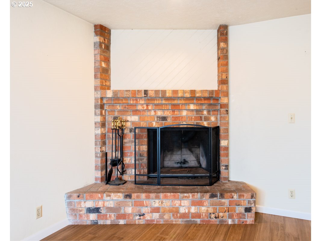 4631 Daisy Street Springfield, OR 97478 - Photo 15 of 46 a living room with a fireplace and a floor to ceiling window
