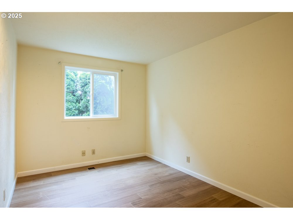 4631 Daisy Street Springfield, OR 97478 - Photo 24 of 46 an empty room with wooden floor and windows