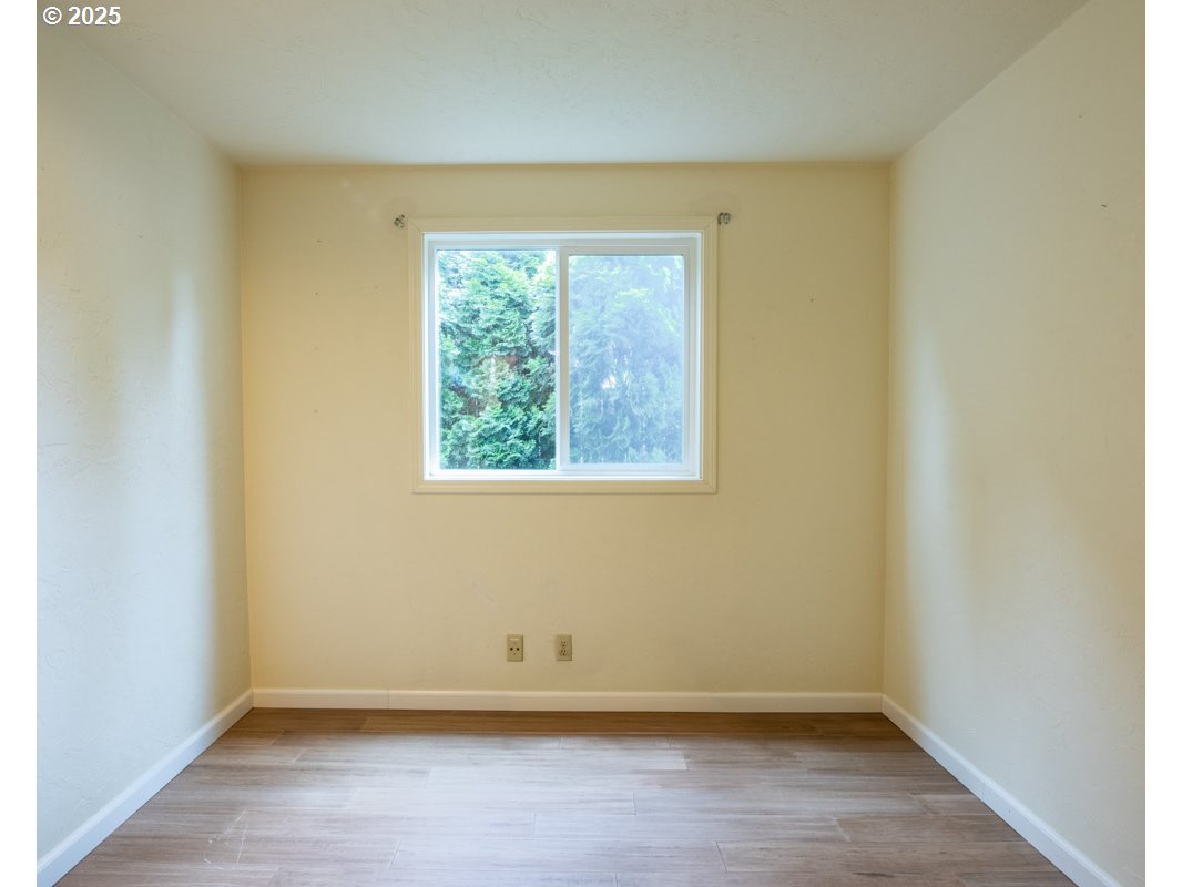 4631 Daisy Street Springfield, OR 97478 - Photo 25 of 46 an empty room with wooden floor and a window