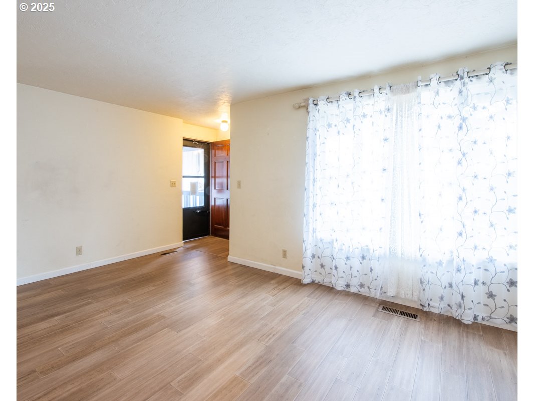 4631 Daisy Street Springfield, OR 97478 - Photo 7 of 46 a view of empty room with wooden floor and fan