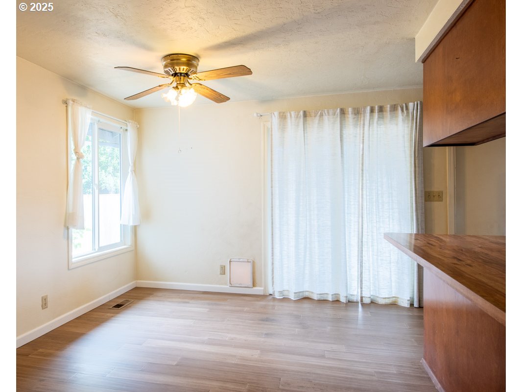 4631 Daisy Street Springfield, OR 97478 - Photo 9 of 46 a view of an empty room with window and wooden floor