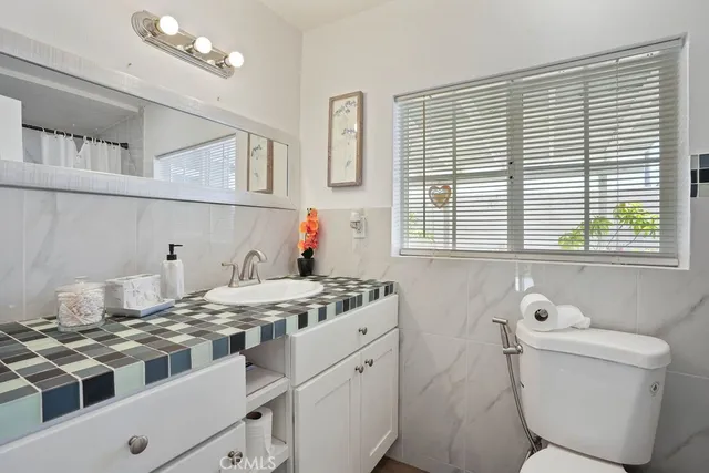 a kitchen with a stove a sink and a window