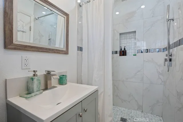 a bathroom with a sink vanity and a mirror