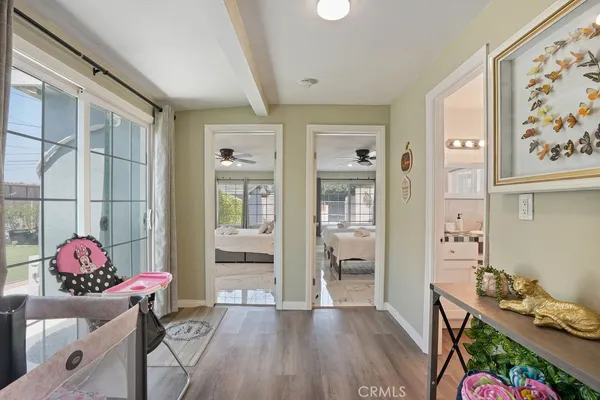 a living room with furniture and wooden floor