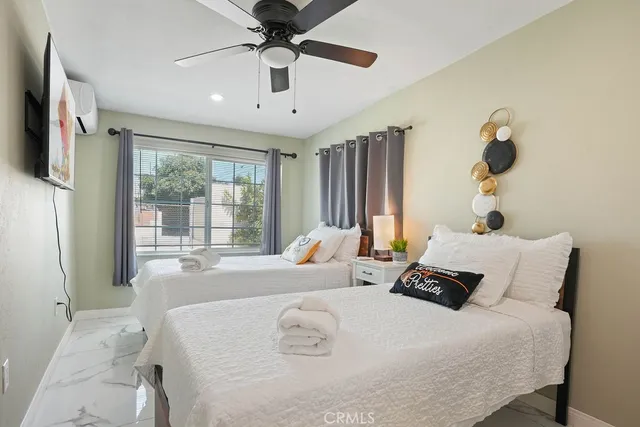 a bedroom with a large bed and a large window