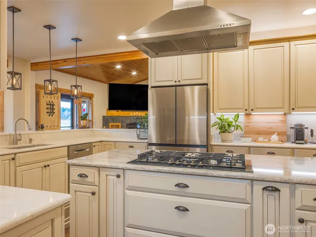 a kitchen with stainless steel appliances granite countertop a stove and a refrigerator