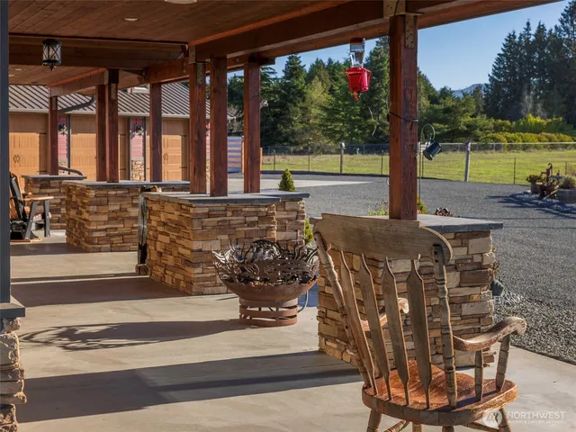 a view of a patio with a table and chairs