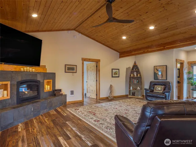 a living room with fireplace furniture and a flat screen tv