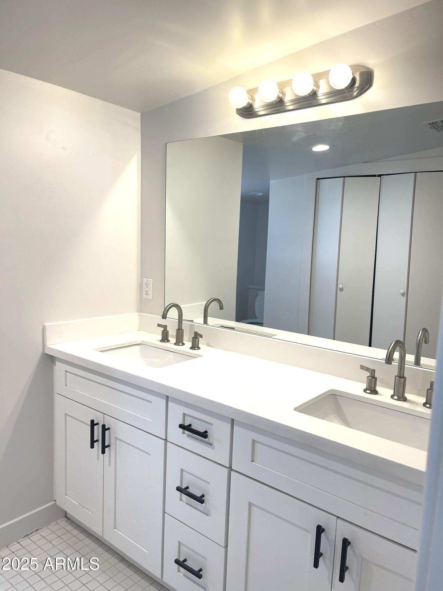 106 East Linda Lane Gilbert, AZ 85234 - Photo 16 of 21 a bathroom with a sink double vanity and a mirror
