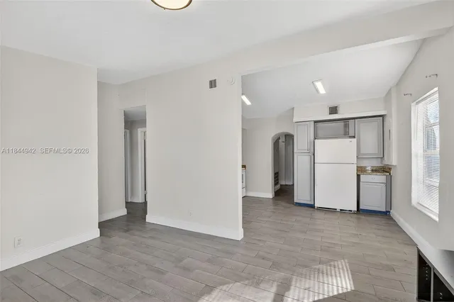 a view of a kitchen with a refrigerator and microwave