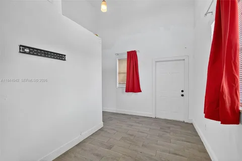 a view of a room with wooden door and stairs