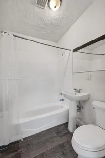 a bathroom with a toilet and a tub