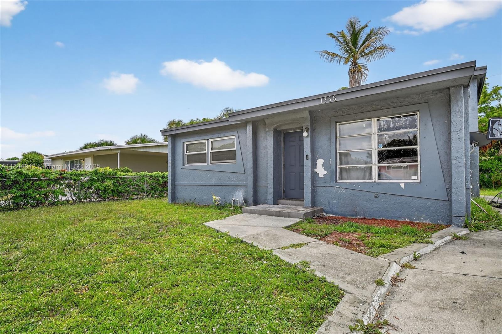 1368 11th Street West Palm Beach, FL 33401 - Photo 3 of 7 a front view of a house with a yard