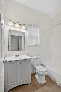 a bathroom with a toilet sink and mirror