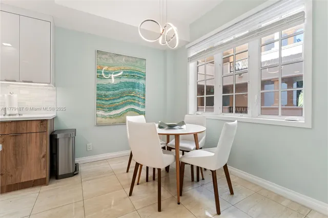 a kitchen with a sink a counter top space stainless steel appliances and cabinets