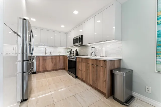 a kitchen with stainless steel appliances granite countertop a refrigerator and a sink