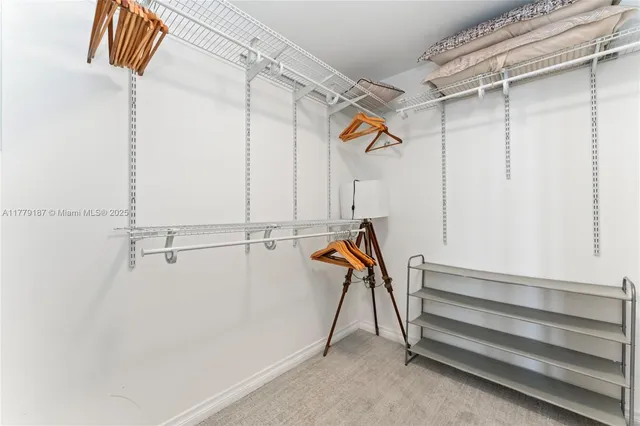 a spacious bathroom with a granite countertop sink a toilet a mirror and shower