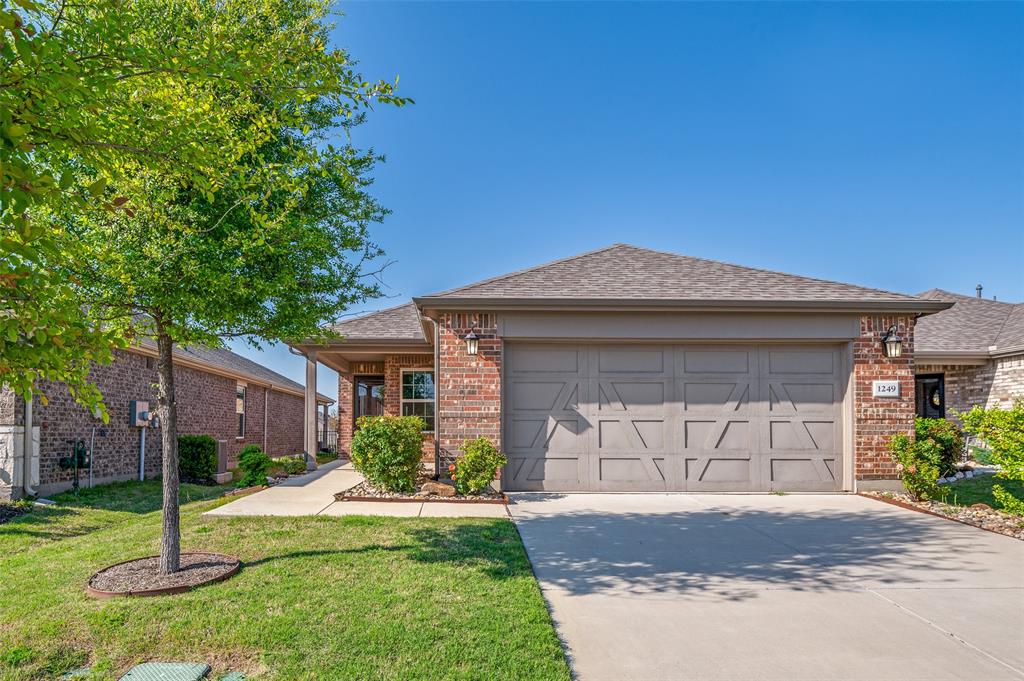 1249 Eagle Lane Aubrey, TX 76227 - Photo 1 of 1 a front view of a house with a yard and garage