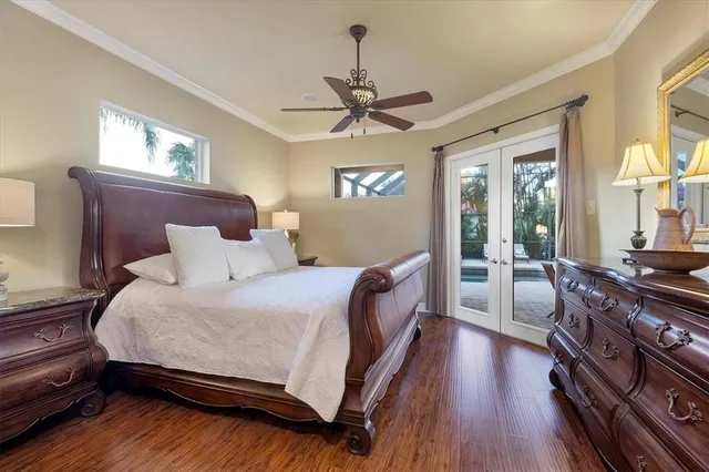 a bedroom with a bed and wooden floor