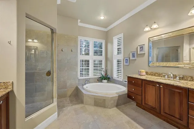 a bathroom with a double vanity sink a toilet a mirror and shower