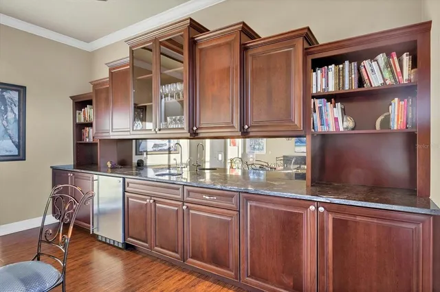 a kitchen with stainless steel appliances granite countertop a stove and cabinets