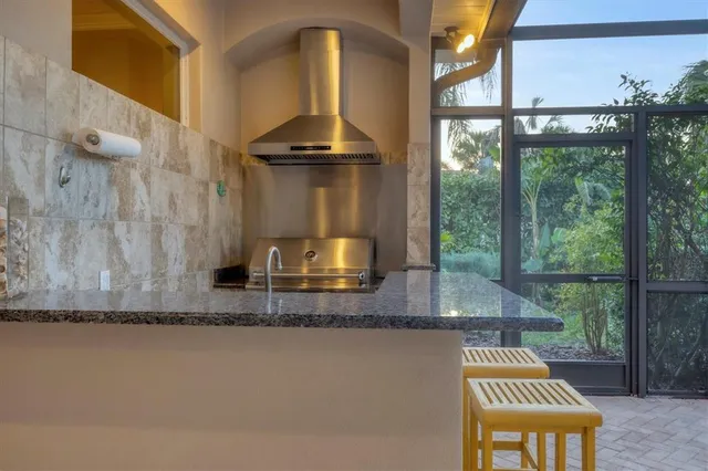 a view of a bathroom with a granite countertop sink a mirror and a shower