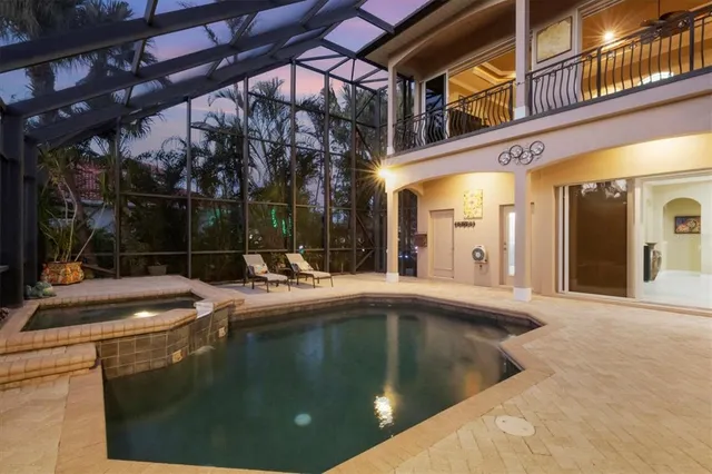 a view of a house with pool and sitting area