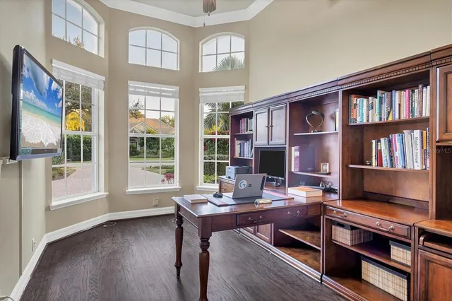 a view of a workspace with furniture and a bookshelf