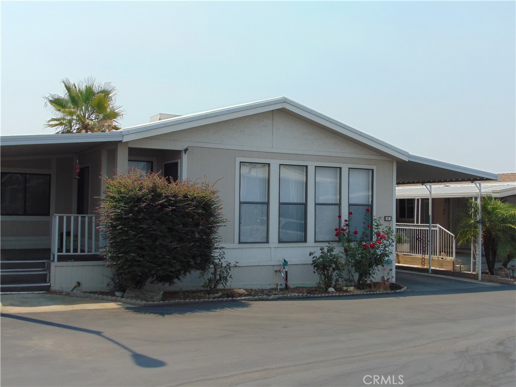 12618 3rd Street, Unit 63 Yucaipa, CA 92399 - Photo 1 of 65 front view of a house with a yard