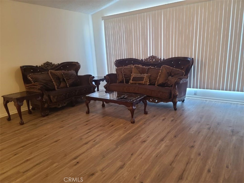12618 3rd Street, Unit 63 Yucaipa, CA 92399 - Photo 14 of 65 a living room with furniture and a wooden floor