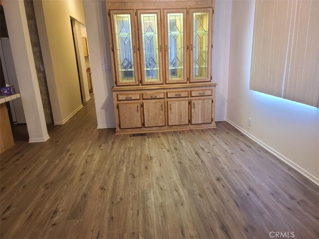 12618 3rd Street, Unit 63 Yucaipa, CA 92399 - Photo 16 of 65 an empty room with wooden floor and windows