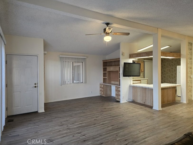 12618 3rd Street, Unit 63 Yucaipa, CA 92399 - Photo 17 of 65 a view of a living room kitchen and flat screen tv
