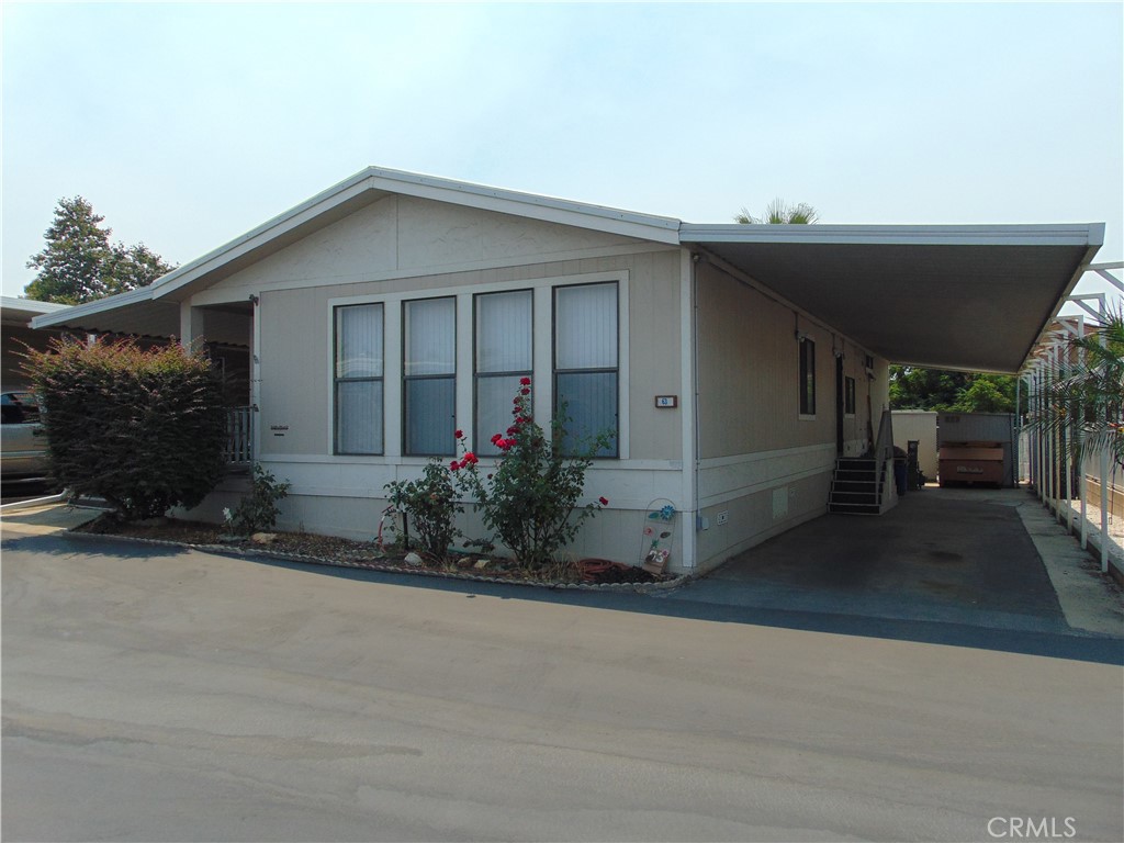 12618 3rd Street, Unit 63 Yucaipa, CA 92399 - Photo 2 of 65 a view of a house with a yard