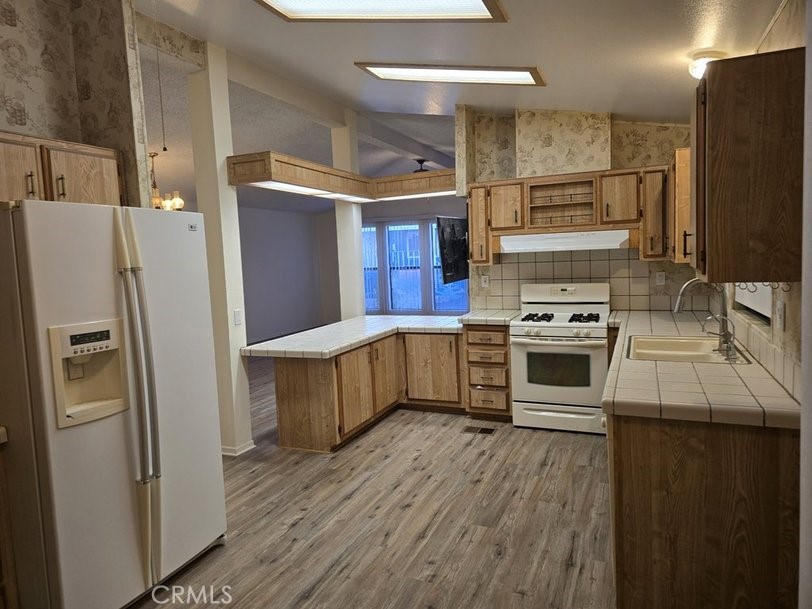 12618 3rd Street, Unit 63 Yucaipa, CA 92399 - Photo 23 of 65 a kitchen with stainless steel appliances a stove a refrigerator and a oven