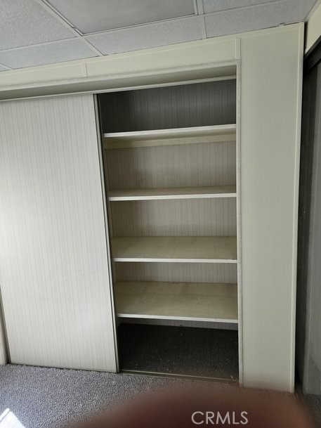 12618 3rd Street, Unit 63 Yucaipa, CA 92399 - Photo 29 of 65 a view of walk in closet with empty racks