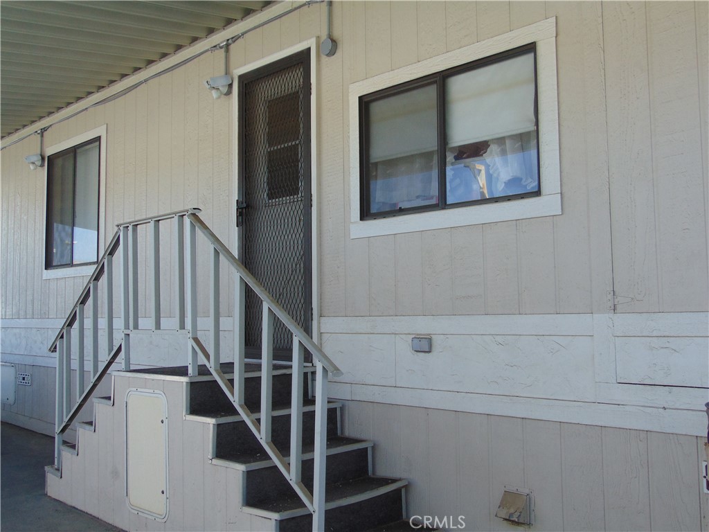 12618 3rd Street, Unit 63 Yucaipa, CA 92399 - Photo 57 of 65 a view of staircase with lots of frames on wall and a window