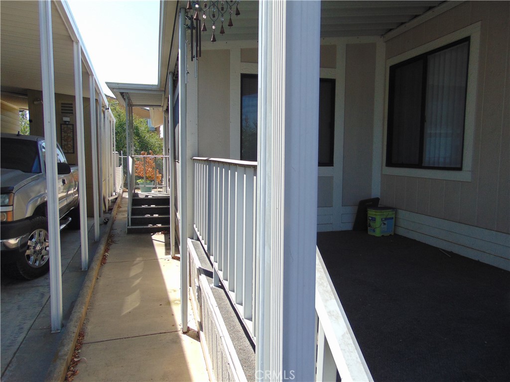 12618 3rd Street, Unit 63 Yucaipa, CA 92399 - Photo 62 of 65 a view of a hallway with wooden floor and a living room