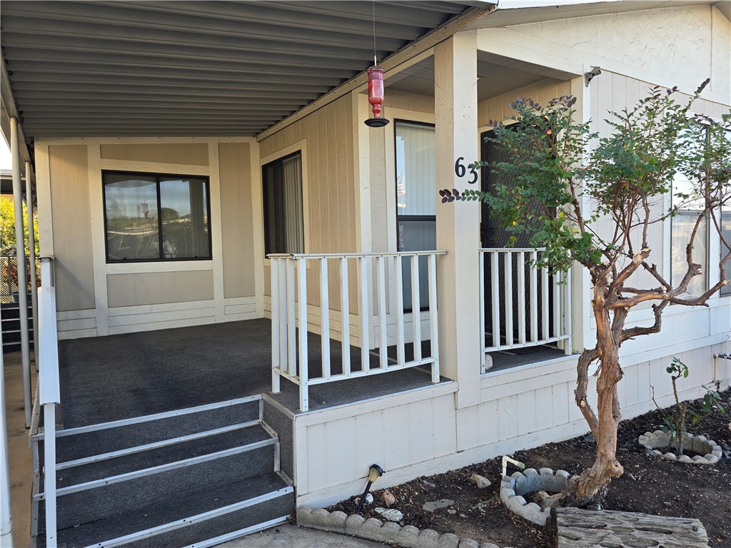 12618 3rd Street, Unit 63 Yucaipa, CA 92399 - Photo 8 of 65 a view of a porch with wooden floor and fence