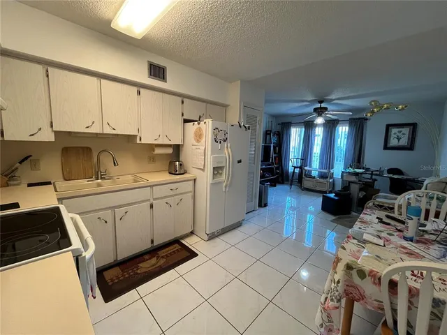 a kitchen with a sink cabinets and refrigerator