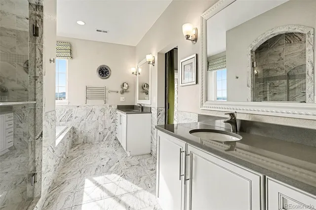 a bathroom with a granite countertop sink mirror and shower