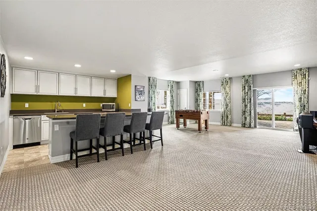 a open kitchen with cabinets table and chairs