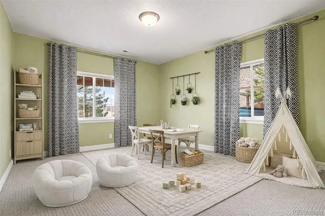a living room with furniture couches and a dining table with wooden floor