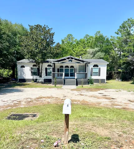 a front view of a house with a garden and swimming pool