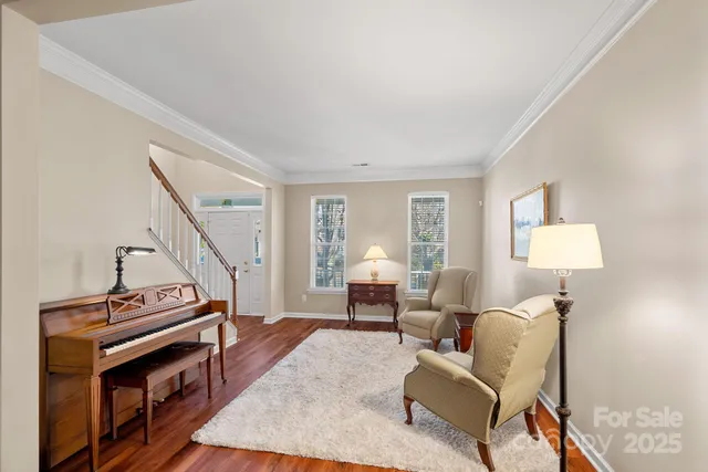 a living room with furniture and a piano
