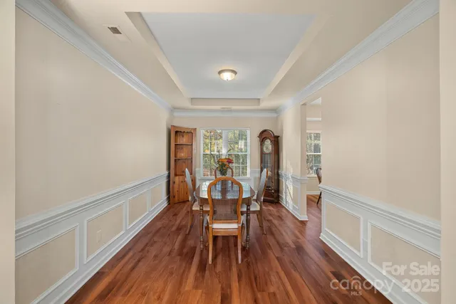 a view of a room with wooden floor and furniture