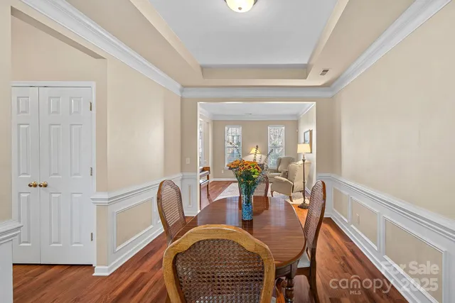 a dining room with furniture and wooden floor