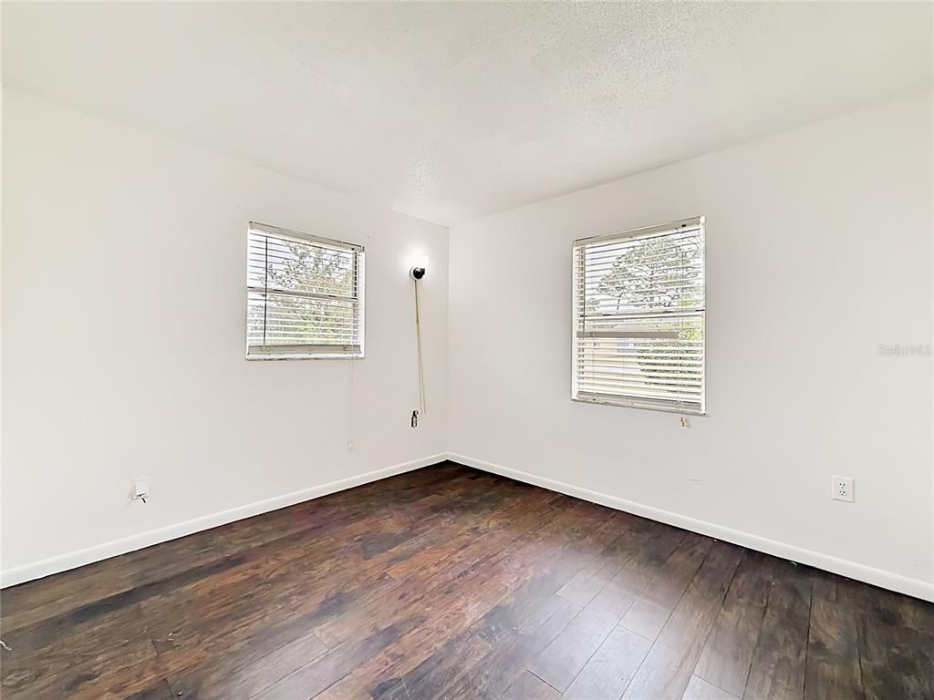 3 Bahia Pl Loop Ocala, FL 34472 - Photo 22 of 31 an empty room with wooden floor and windows