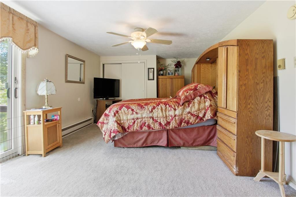 776 Fraction Road West Finley, PA 15377 - Photo 26 of 43 a bedroom with a bed and a chandelier